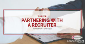 Blog Cover Image; Tips For Partnering With a Recruiter In Your Career Search | Shaking Hands over a desk with resume